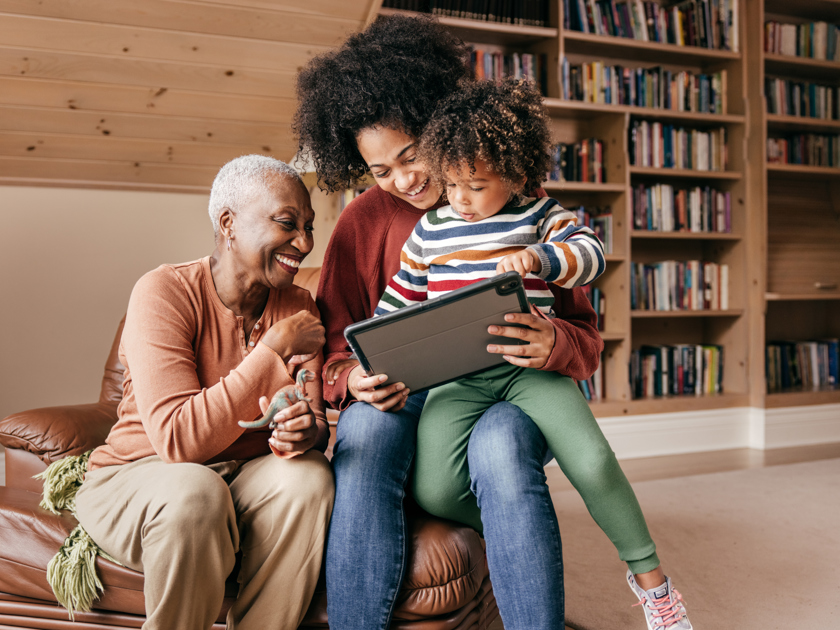 Happy family looking at a tablet together